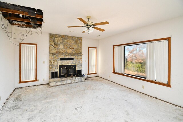 unfurnished living room featuring a fireplace and a ceiling fan