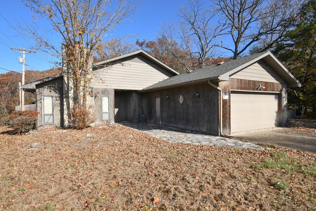 view of side of home with an attached garage
