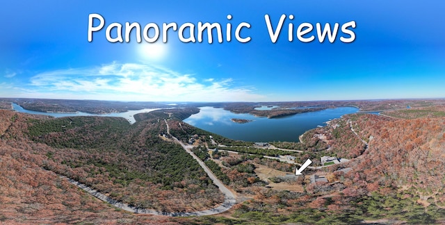 bird's eye view of a nearby body of water and a heavily wooded area