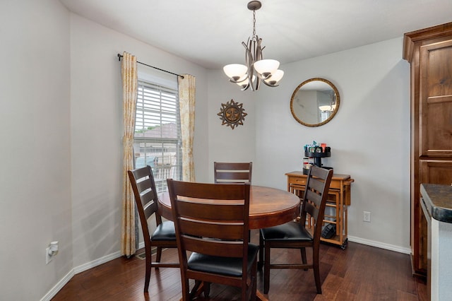 dining room with a chandelier, dark wood-style floors, and baseboards