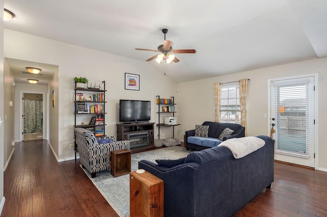 living area with lofted ceiling, dark wood-style floors, ceiling fan, and baseboards