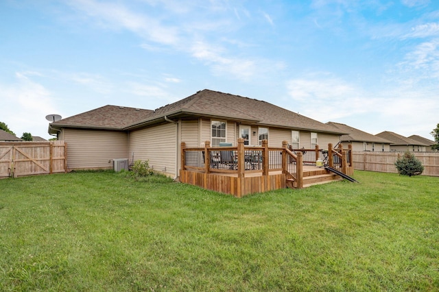 rear view of property with a deck, central air condition unit, and a shingled roof