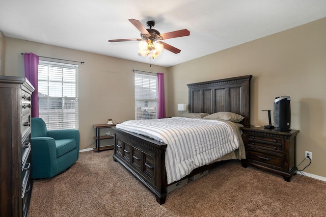 carpeted bedroom featuring baseboards and a ceiling fan