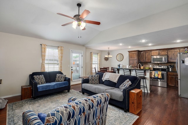 living area featuring dark wood-type flooring, a ceiling fan, lofted ceiling, recessed lighting, and a chandelier