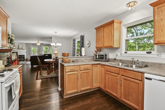 138 Canyon Forest Cir, Kimberling City, MO 65686 - kitchen featuring white appliances, a peninsula, open floor plan, dark wood-type flooring, and a fireplace
