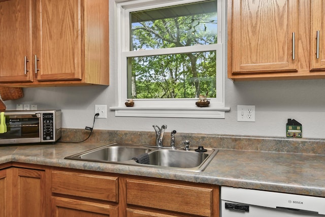 138 Canyon Forest Cir, Kimberling City, MO 65686 - kitchen with dishwasher, a sink, and brown cabinetry