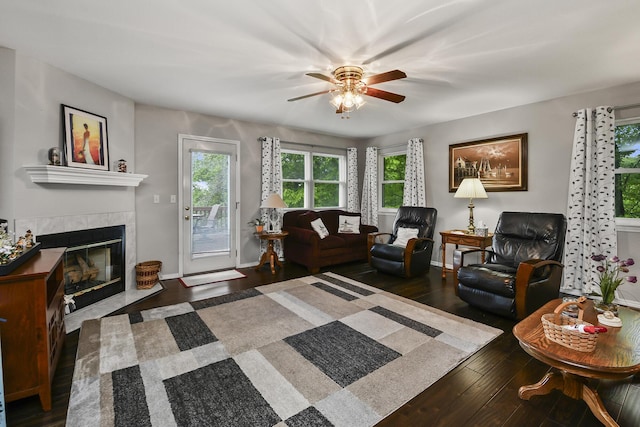 138 Canyon Forest Cir, Kimberling City, MO 65686 - living room featuring ceiling fan, wood finished floors, a tiled fireplace, and baseboards