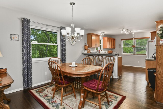 138 Canyon Forest Cir, Kimberling City, MO 65686 - dining room with a chandelier, baseboards, and dark wood-type flooring