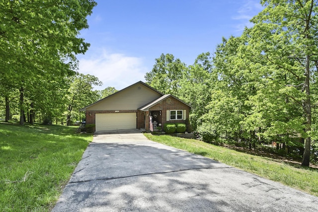138 Canyon Forest Cir, Kimberling City, MO 65686 - ranch-style house featuring a garage, driveway, brick siding, and a front yard