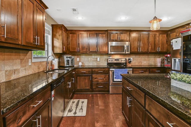 2107 S Gristmill Ct, Ozark, MO 65721 - kitchen featuring appliances with stainless steel finishes, a sink, dark wood-style floors, decorative backsplash, and recessed lighting