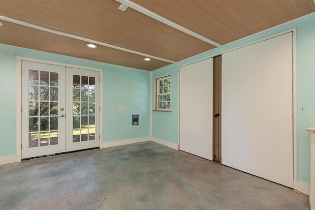 unfurnished room with french doors, plenty of natural light, recessed lighting, finished concrete flooring, and wooden ceiling