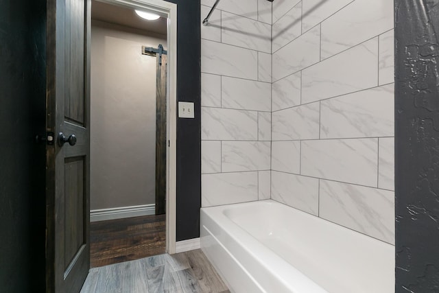 bathroom with wood finished floors and tub / shower combination