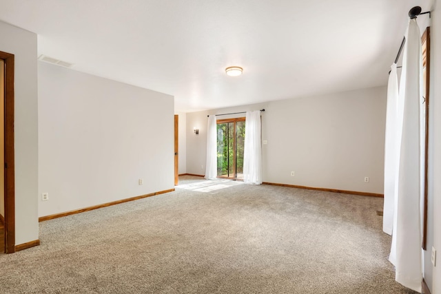 carpeted spare room with baseboards