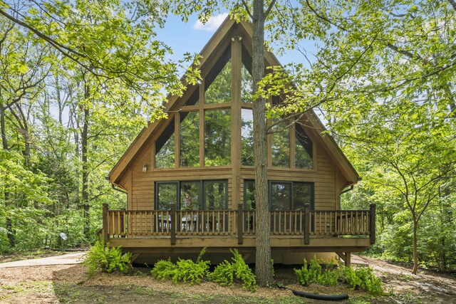 back of property featuring a deck