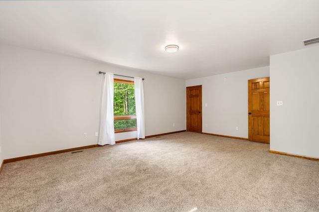 empty room with light carpet and baseboards