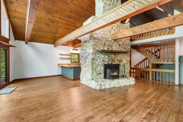 unfurnished living room featuring high vaulted ceiling, baseboards, stairway, wood-type flooring, and wood ceiling