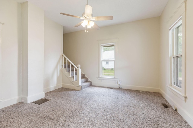 901 W Poplar St, Springfield, MO 65802 - carpeted empty room with stairs, ceiling fan, and baseboards