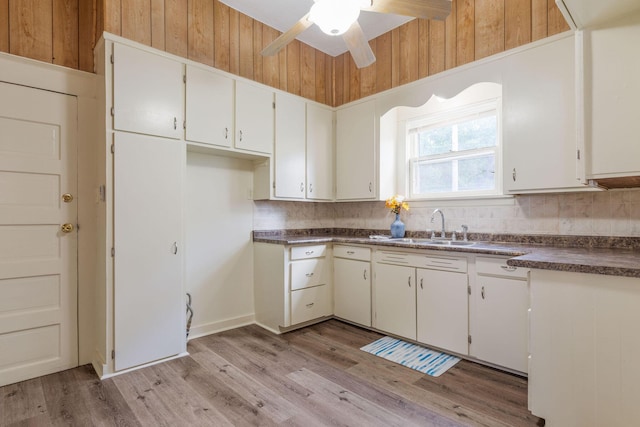 901 W Poplar St, Springfield, MO 65802 - kitchen featuring dark countertops, decorative backsplash, a ceiling fan, light wood-style floors, and white cabinets