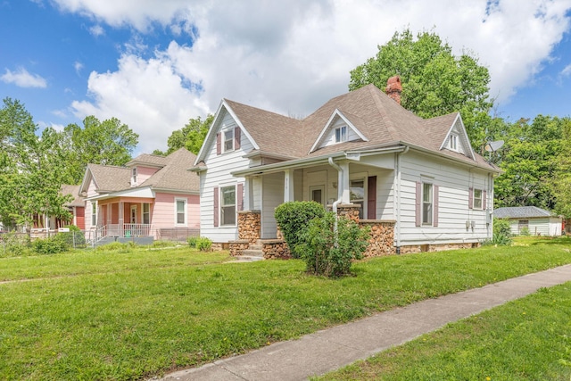 901 W Poplar St, Springfield, MO 65802 - view of front of home with covered porch, a chimney, roof with shingles, and a front yard