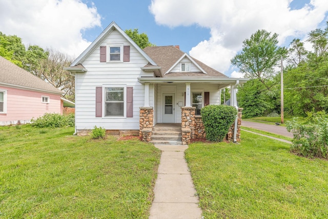 901 W Poplar St, Springfield, MO 65802 - view of front of home with a front yard, covered porch, and roof with shingles