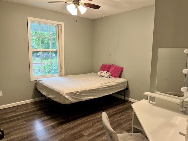 bedroom with wood finished floors, baseboards, and ceiling fan