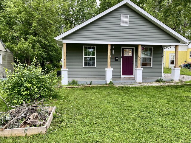 view of front of home featuring a porch and a front yard