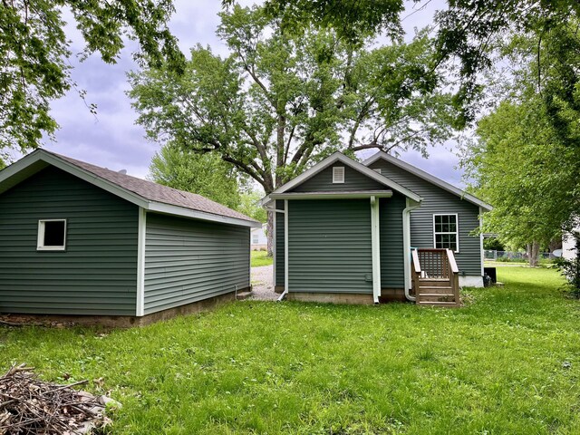 rear view of property featuring a yard