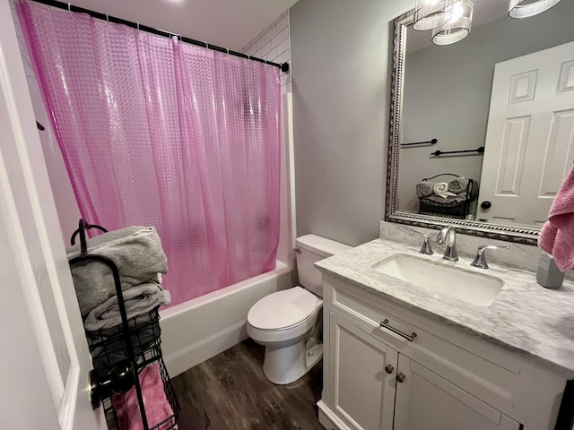 bathroom with wood finished floors, toilet, shower / tub combo, and vanity