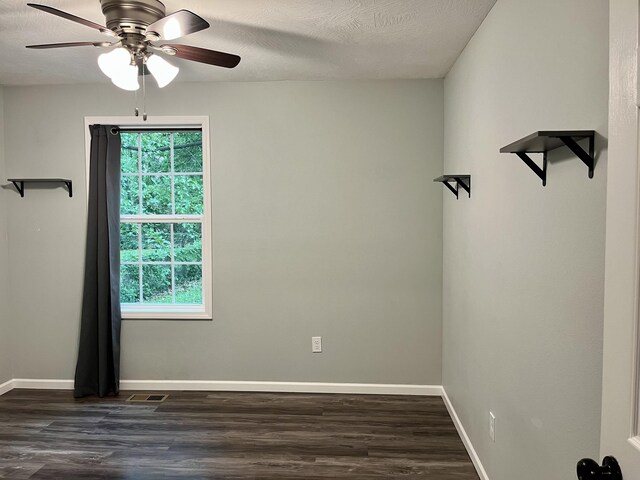 unfurnished room with a ceiling fan, dark wood-style floors, and baseboards