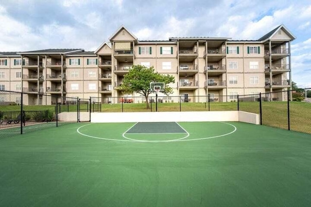 view of basketball court featuring fence and community basketball court