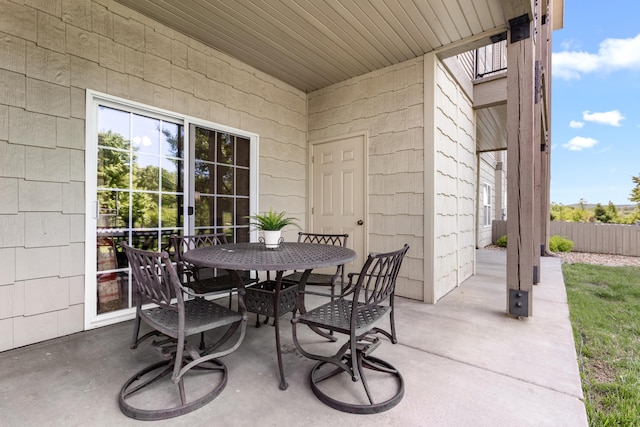 view of patio featuring fence and outdoor dining area