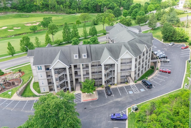 bird's eye view of a golf course and apartment complex / building
