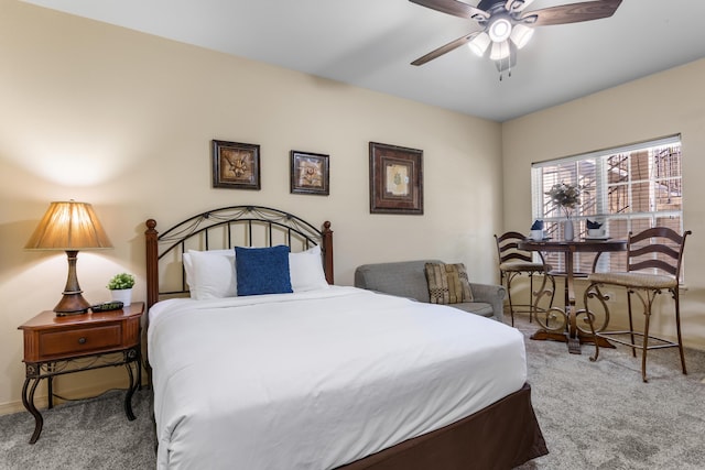 carpeted bedroom with a ceiling fan and baseboards