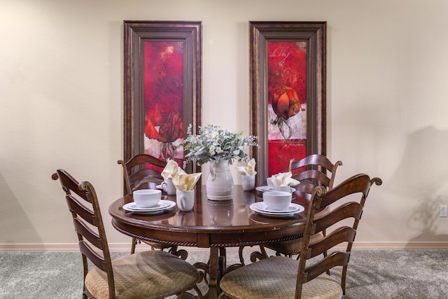 dining room with carpet floors and baseboards