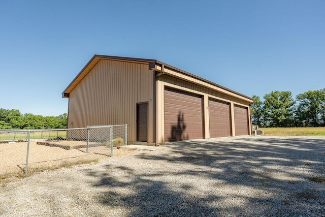 3701 S 1500th Rd, Rich Hill, MO 64779 - view of side of property with fence, a detached garage, and an outdoor structure