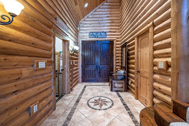 3701 S 1500th Rd, Rich Hill, MO 64779 - entryway featuring log walls, inlaid floor details, and a towering ceiling