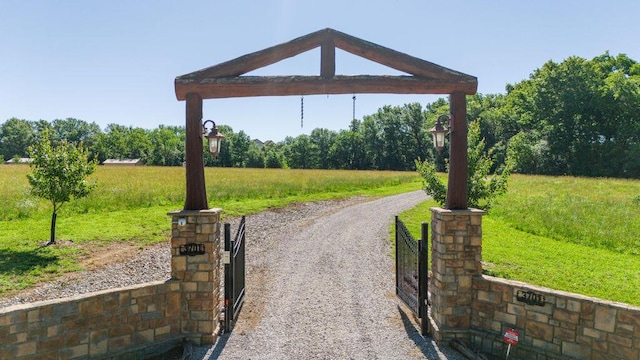 3701 S 1500th Rd, Rich Hill, MO 64779 - surrounding community with a lawn and a gate