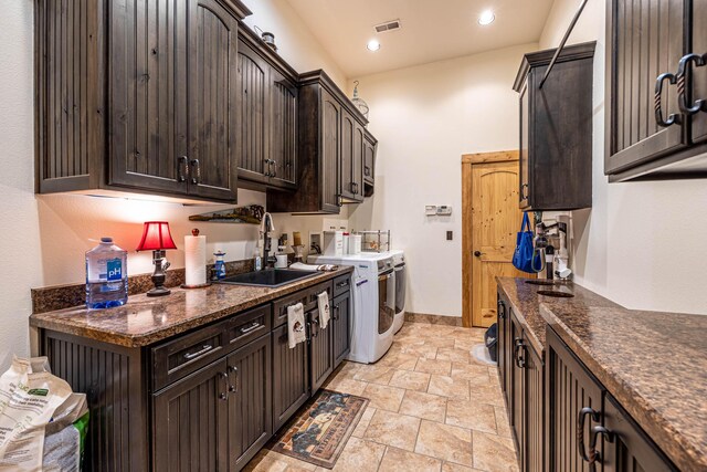 3701 S 1500th Rd, Rich Hill, MO 64779 - kitchen with a sink, dark brown cabinets, independent washer and dryer, light stone finish floors, and recessed lighting