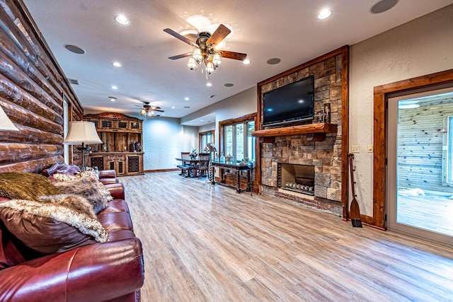3701 S 1500th Rd, Rich Hill, MO 64779 - living room with ceiling fan, a stone fireplace, wood finished floors, recessed lighting, and baseboards