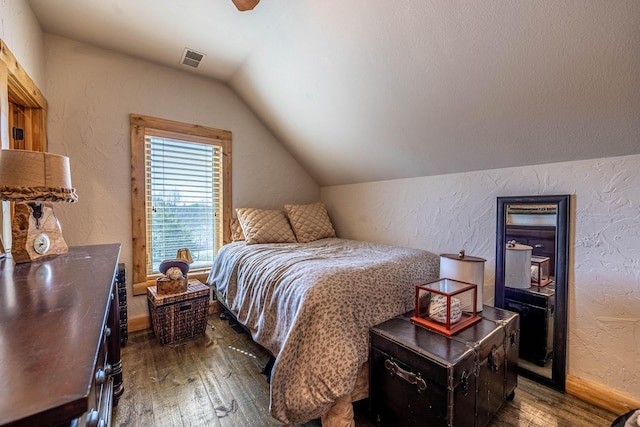 3701 S 1500th Rd, Rich Hill, MO 64779 - bedroom with dark wood-style floors, vaulted ceiling, a textured wall, and baseboards