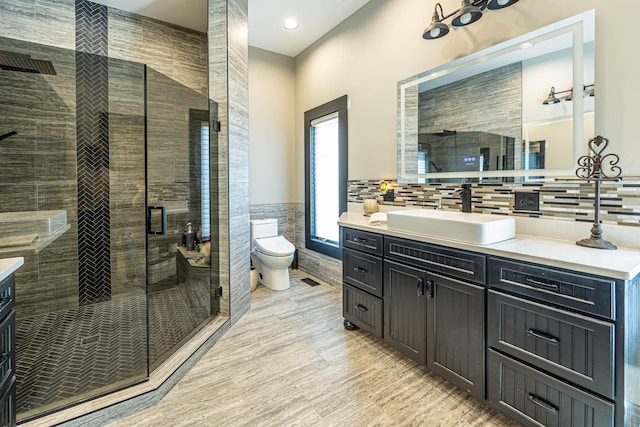 3701 S 1500th Rd, Rich Hill, MO 64779 - bathroom with a shower stall, toilet, vanity, tile walls, and wood finished floors
