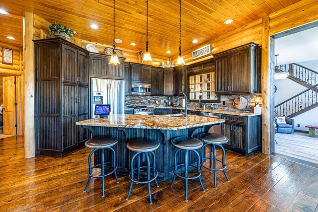 3701 S 1500th Rd, Rich Hill, MO 64779 - kitchen featuring stainless steel appliances, dark wood finished floors, light stone counters, dark brown cabinetry, and wooden ceiling