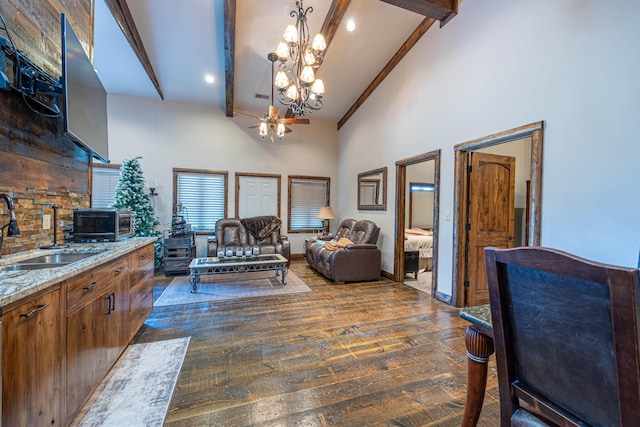 3701 S 1500th Rd, Rich Hill, MO 64779 - living room with beam ceiling, dark wood-type flooring, high vaulted ceiling, a chandelier, and ceiling fan