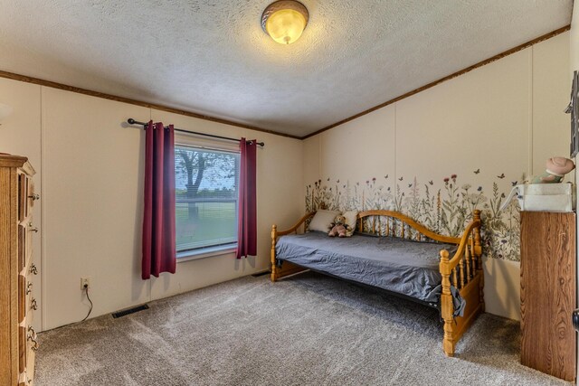 bedroom with crown molding, a textured ceiling, and carpet floors