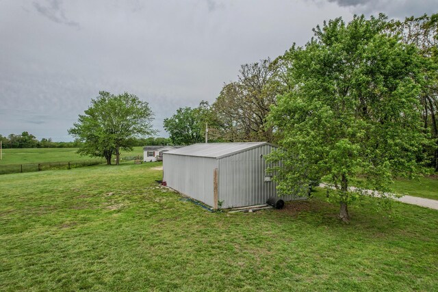 view of yard with an outdoor structure and a shed