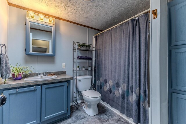bathroom featuring vanity, toilet, crown molding, a shower with shower curtain, and a textured ceiling