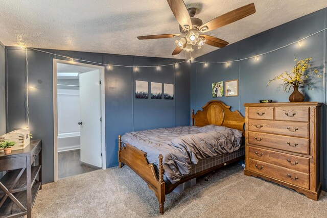 bedroom with carpet, a textured ceiling, and ceiling fan