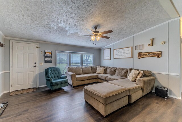 living area with ornamental molding, dark wood finished floors, lofted ceiling, ceiling fan, and a textured ceiling
