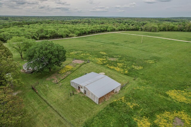 aerial view of sparsely populated area featuring a forest