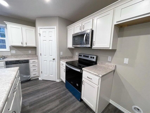 335 Mccann Rd, Powersite, MO 65731 - kitchen featuring appliances with stainless steel finishes, dark wood-style flooring, white cabinetry, and baseboards